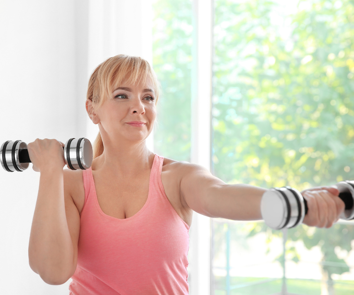 Woman training with dumbbells